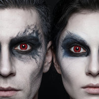 Man and woman wearing Freak contact lenses with heavy charcoal-black smoky Halloween makeup