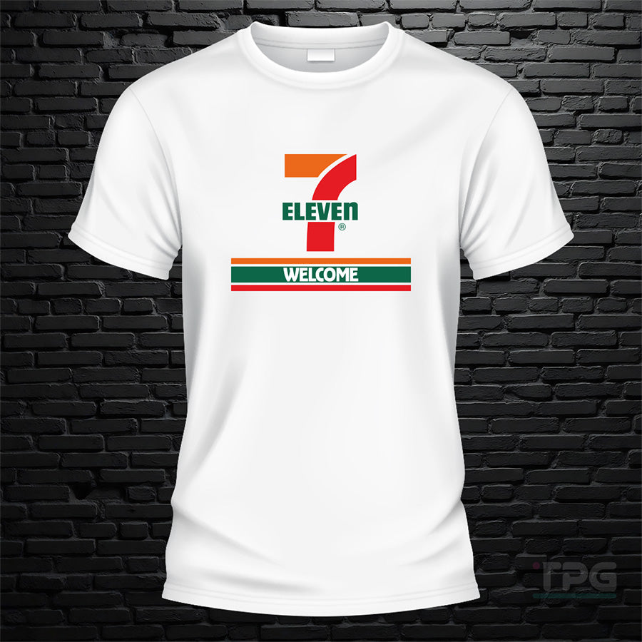 7 11 graphic T-shirt welcome sign graphic on white brick wall