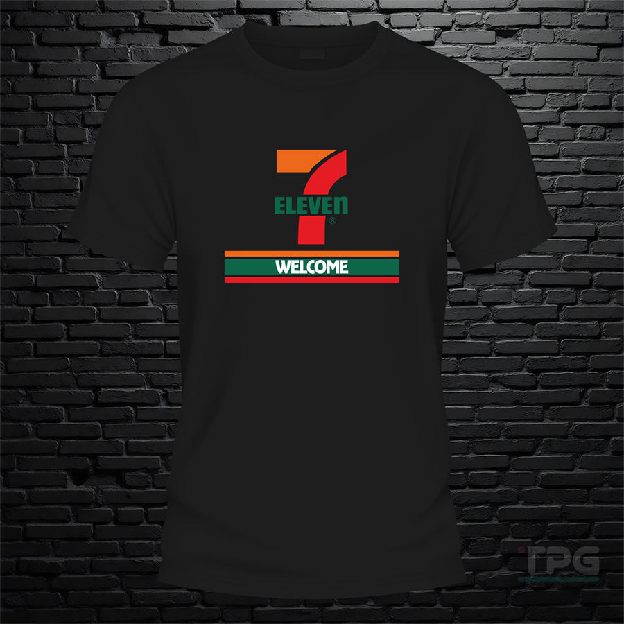 7 11 graphic T-shirt welcome sign graphic on black brick wall